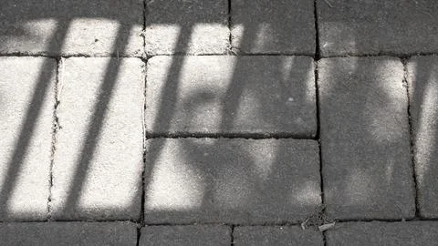 Pedestrian With Asymmetric Square Pattern. The sun's shadow overlay on the .. Stock Photos