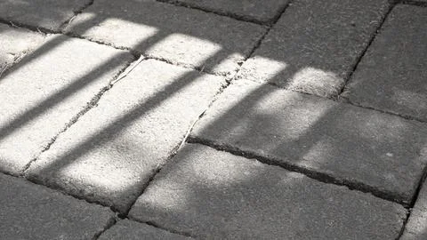 Pedestrian With Asymmetric Square Pattern. The sun's shadow overlay on the .. Stock Photos