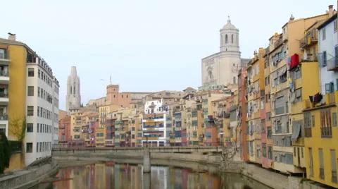 Pedestrian bridge over river in old town, with 2 cathedral belfries Stock Footage 42178421