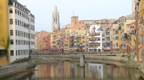Pedestrian bridge over river in old town, with church belfry Stock Footage 42179607