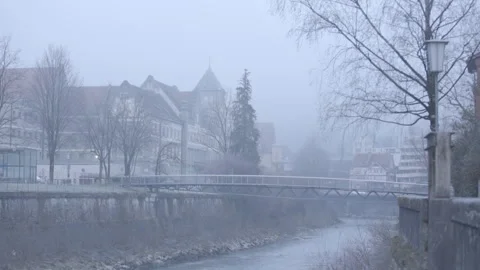 Pedestrian bridge over a small river on a foggy morning Stock Footage 264840935
