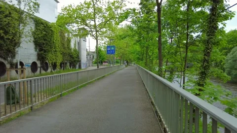 Pedestrian bridge path along Limmat river with ivy wall in Zurich Stock Footage 334629659