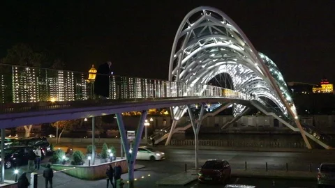 Pedestrian bridge of peace over the Mtkvari Kura River in Tbilisi - night shot. Stock Footage 98406761