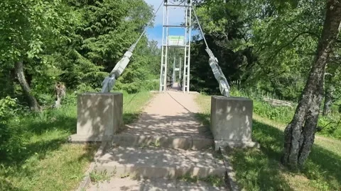 Pedestrian cable bridge over the Amata River. Video stock 303563409