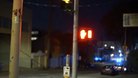 Pedestrian countdown timer on walkway counting down until orange man at night Stock Footage 233468654