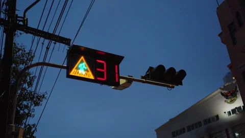 Pedestrian countdown traffic light against blue sky Stock Footage 346212872