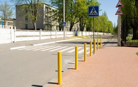 A pedestrian crossing is equipped, empty, without people. Stock Photos