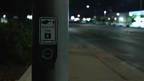 Pedestrian crossing push button on an empty city street at night Stock Footage 346922347