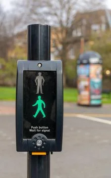 Pedestrian crossing push button unit showing green walk signal Stock Photos