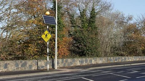 Pedestrian crossing with a solar panel. Stock Photos