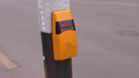 Pedestrian hand pressing crosswalk button waiting for signal 動画素材 337557576