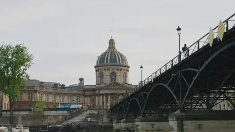 The pedestrian iron bridge Pont des Arts, the Institut de France and moored boat Stock Footage 308731957