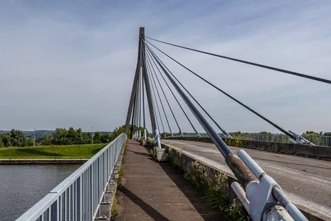 Pedestrian or cycling path parallel to rural road on cable-stayed bridge 库存照片