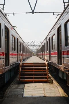 Pedestrian path on the platform in the station in the middle of two trains Stock Photos