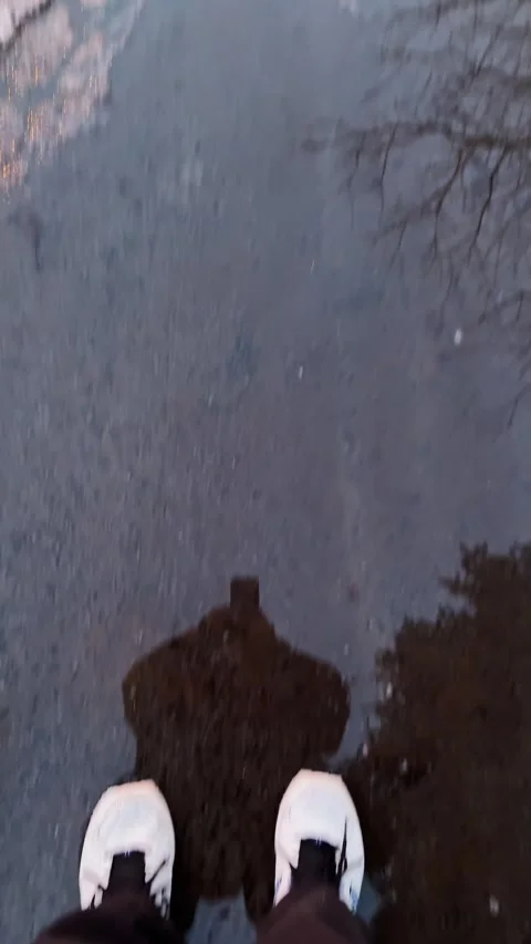 Pedestrian POV Avoiding Slushy Puddle On Icy Pedestrian Path During Spring Thaw Stock Footage 331902193