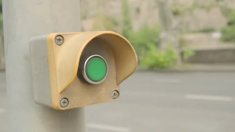 Pedestrian pressing button to cross road with car traffic Stock Footage 292307707