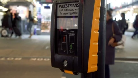 Pedestrian pushes button and waits for the green sign at a crossing Stock Footage 100591043