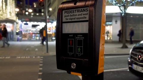 Pedestrian pushes button and waits for the green sign at a crossing. Stock Footage 100622380