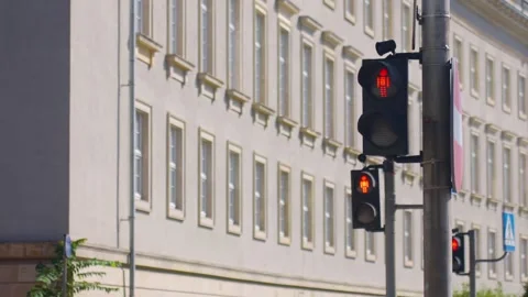 Pedestrian signal changes from red stop symbol to green walking figure Stock Footage 345936603