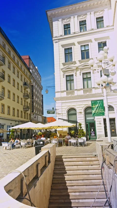 Pedestrian subway steps lead up to Victory Square where outdoor restaurant Stock Footage 339014900