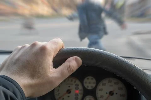 A pedestrian throws himself under a car Stock Photos