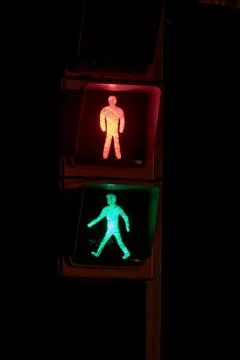 Pedestrian traffic light with both red and green lights illuminated at the sa Stock Photos