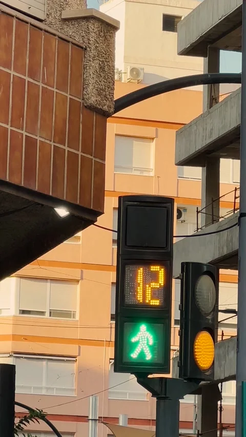 Pedestrian traffic light changing from red to green with a countdown timer Stock Footage 346804466