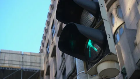 Pedestrian traffic light in the city changes from green to red Stock Footage 236015683