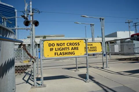 Pedestrian transit train crossing warning signs in city. Stock Photos
