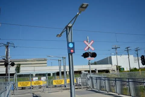 Pedestrian transit train crossing with warning lights. Stock Photos