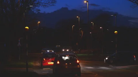 Pedestrian using zebra crossing at twilight leeds Yorkshire uk Stock Footage 125803177