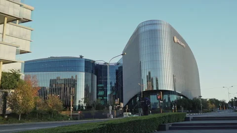 Pedestrian walking in front of the Discovery building in Sandton Stock Footage 132452335