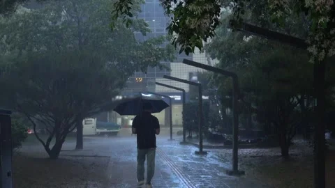 A pedestrian walking in heavy rain Stock Footage 333493103