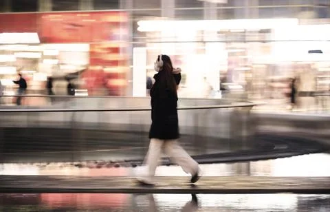 Pedestrian walking motion blur city lights Stock Photos