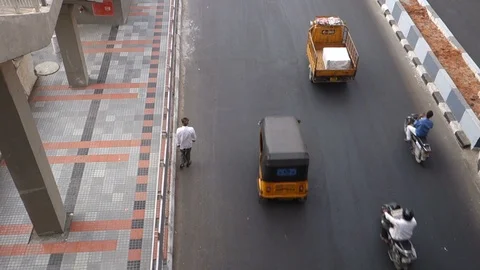 Pedestrian-walking-next-to-sidewalk-on-a-busy-street Stock Footage 96197168