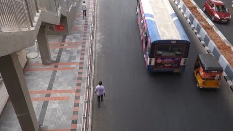 Pedestrian-walking-next-to-sidewalk-on-a-busy-street-2 Stock Footage 96197183