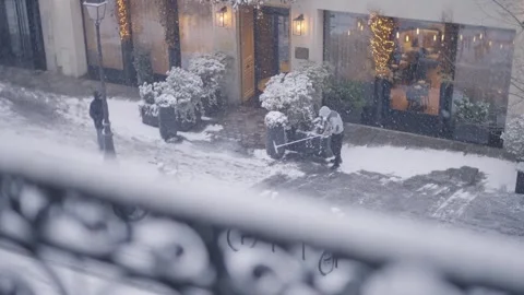Pedestrian Walking Through Snowstorm Past Christmas Shopfront Stock Footage 340546523