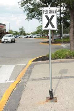 Pedestrian x vertical rectangle white black sign on metal post with parking lot Foto stock