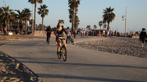 Pedestrians and cyclists on a bike path at Venice Beach, California Stock Footage 59335557
