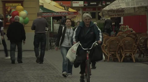 Pedestrians and cyclists passing through European town of Trenčín, Slovakia Stock Footage 8519215