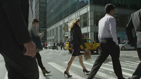 Pedestrians in business dress crossing a busy New York City street Stock Footage