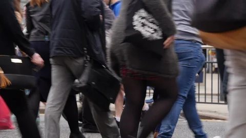 Pedestrians crossing at a busy intersection Stock Footage 98180931