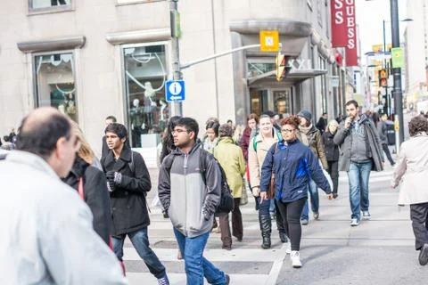 Pedestrians crossing a busy intersection Stock Photos