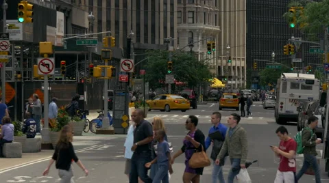 Pedestrians crossing zebra urban Manhattan street traffic New York City NYC day Stock Footage