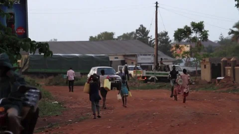 Pedestrians On A Dirt Road In Uganda Stock Footage