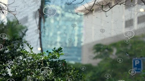Pedestrians entering frame walking past hedge, brain-chip icons hovering above Stock Footage 333510006