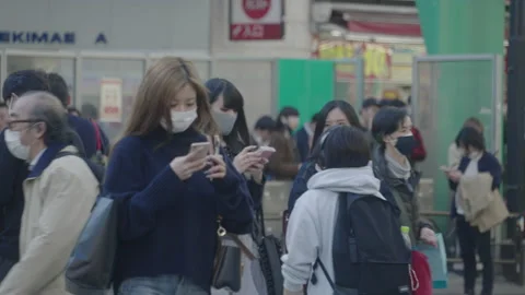 Pedestrians In Face Mask Using Their Smart Phone While Walking The Road Of Vídeos de archivo 144294291