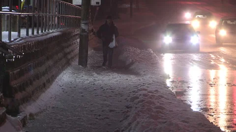 Pedestrians getting splashed and soaked by passing cars on winter night. Stock Footage 45597491