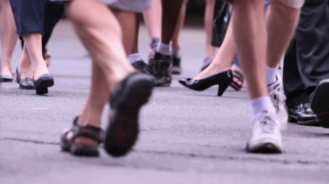 Pedestrians legs as they cross at an intersection Stock Footage