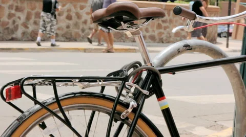 Pedestrians Move on Sidewalk Behind a Black Bicycle Stock Footage 64833793